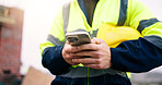 Architect, texting and hands with phone on construction site, online and communication with contact. Civil engineering, chat and person with mobile, low angle and property development update on app