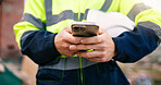 Architect, chatting and hands with phone on construction site, online and communication with contact. Civil engineering, low angle and person with mobile, texting and property development update