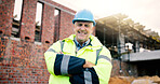 Construction site, engineer and happy man with confidence outdoor for building development with helmet. Arms crossed, portrait and mature architect with smile, about us or safety inspector with pride