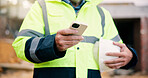 Civil engineer, message and hands with phone on construction site, chat or communication on website. Architect, outdoor and person with mobile, texting and property development update on social media