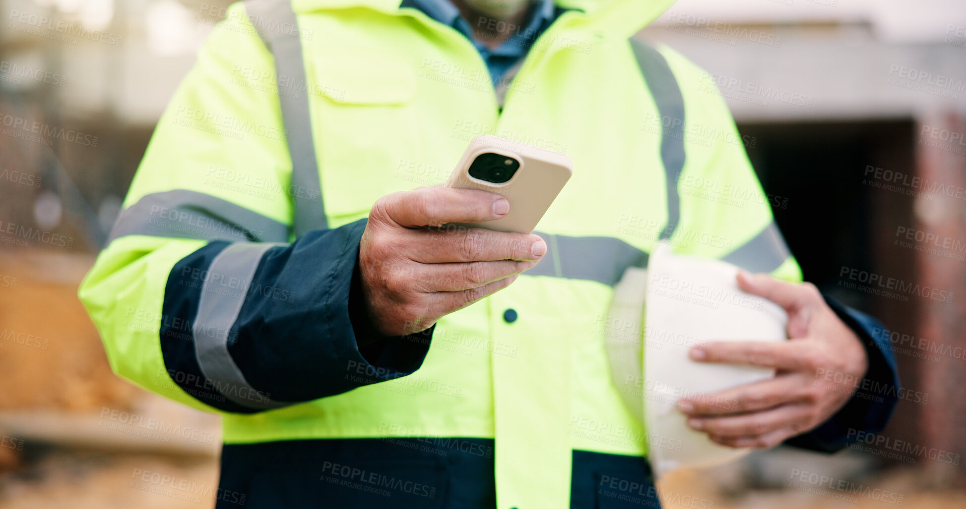 Buy stock photo Civil engineer, message and hands with phone on construction site, chat or communication on website. Architect, outdoor and person with mobile, texting and property development update on social media
