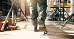 Boots, person and walking on construction site for renovation, contractor and inspection of building progress. Foreman, engineering and shoes for remodel, infrastructure upgrade or project management