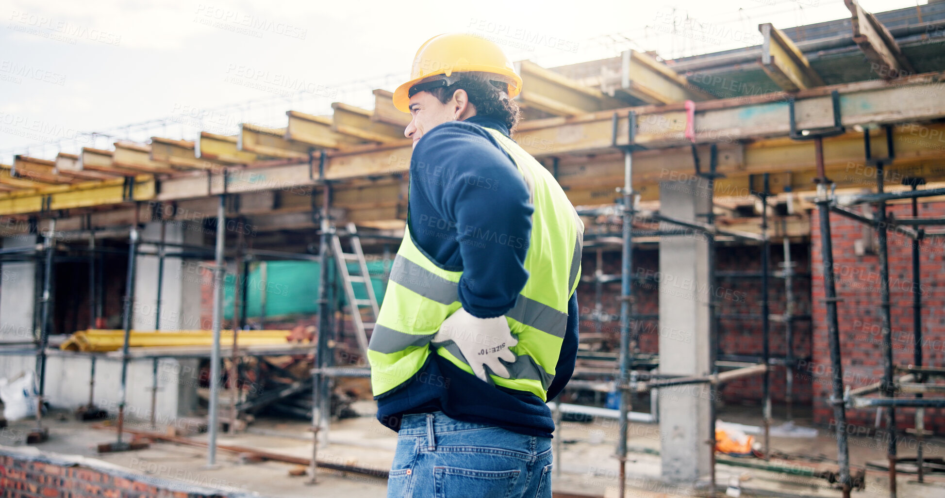 Buy stock photo Back pain, stress and man on construction site with injury, muscle fatigue and tension. Contractor, engineer and person with sprain, fibromyalgia and pressure for burnout, posture strain and accident