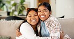 Hug, sisters and kids with love in home, happy girls and bonding together with connection. Portrait, smile and siblings embrace on sofa for support, trust and care with security at family house