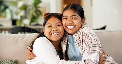 Buy stock photo Hug, sisters and kids with love in home, happy girls and bonding together with connection. Portrait, smile and siblings embrace on sofa for support, trust and care with security at family house