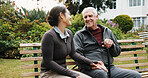 Support, holding hands and old man with caregiver at garden for wellness, rehabilitation and relax. Carer, retirement and happy person outdoor with cane, trust and bonding for connection on bench