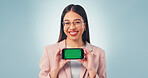 Portrait, businesswoman and phone in studio with green screen, smile and website for digital marketing. Happy, person and worker with tech, advertising mobile app and mockup space on blue background.