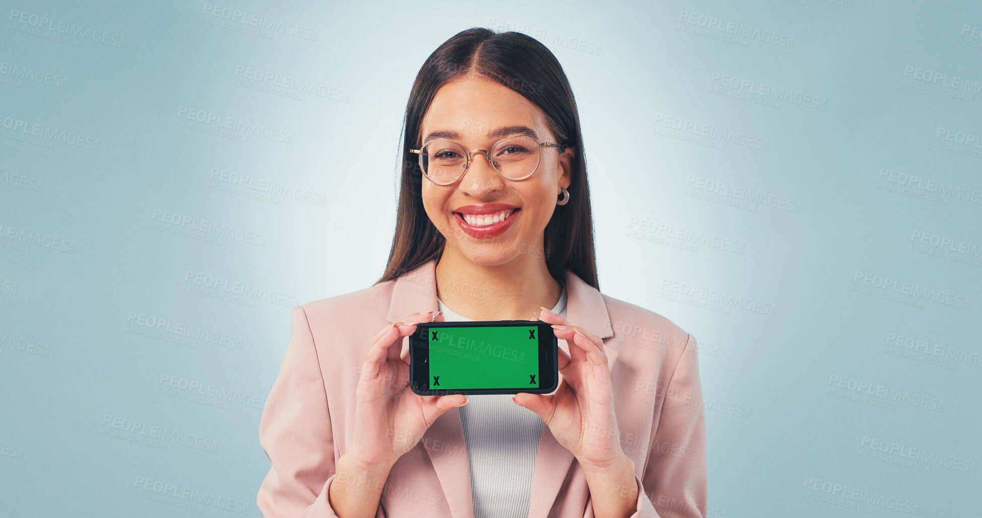 Buy stock photo Portrait, businesswoman and phone in studio with green screen, smile and website for digital marketing. Happy, person and worker with tech, advertising mobile app and mockup space on blue background.