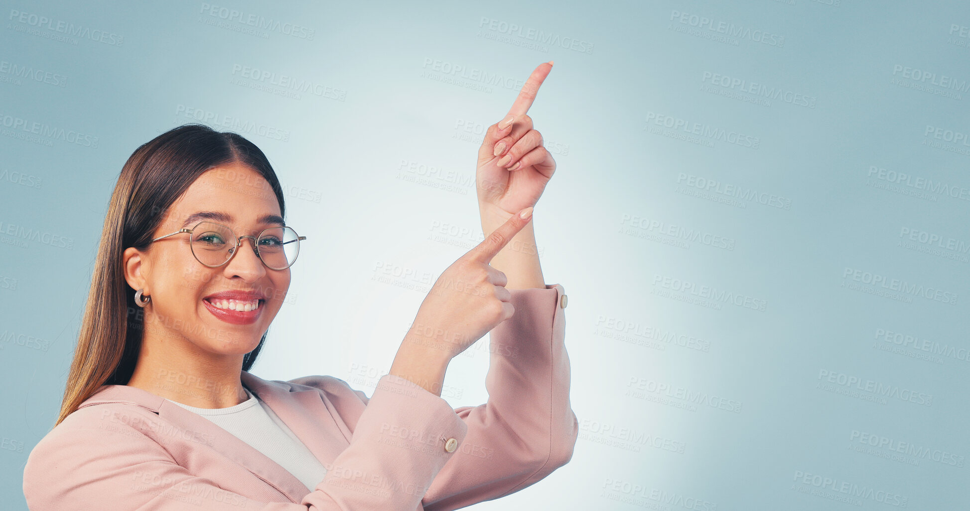 Buy stock photo Happy, woman and pointing in studio with portrait, advertising and announcement for interview. Smile, mockup space and person with gesture, application and opinion for recruitment on blue background