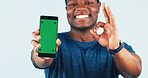 Black man, phone and green screen in studio with approval for app, fitness or exercise program. Mockup space, okay gesture and person with tech for promotion or social media on white background