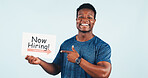 Black man, fitness and portrait in studio with hiring sign for job opportunity, offer or recruitment. Happy, African person or gym owner with smile, mockup space or poster on white background