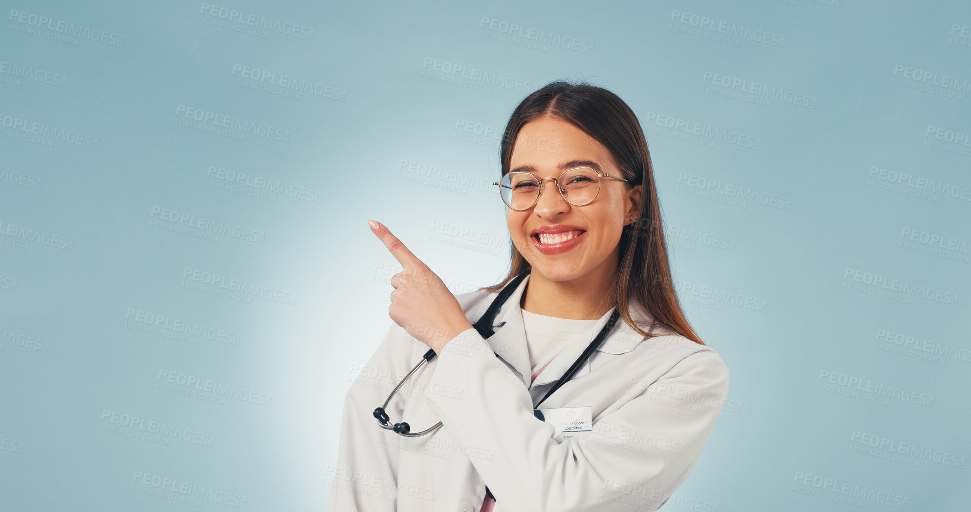 Buy stock photo Medical, portrait and doctor with pointing, treatment advice and reminder on wellness info. Mockup space, happy woman and gp with instruction, recovery plan or healthcare insight on studio background