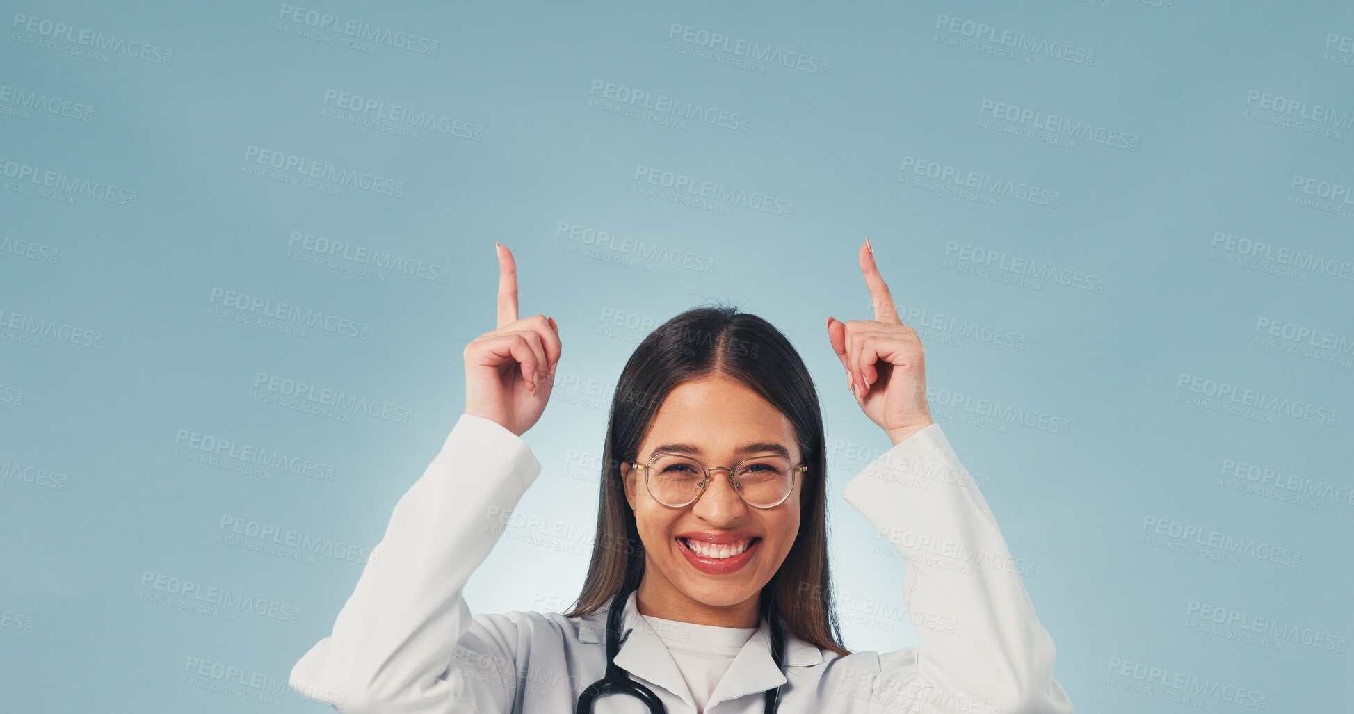 Buy stock photo Doctor, pointing and happy woman in studio, offer and presentation for healthcare service or advice. Blue background, medical expert and person with smile, portrait and health options with space
