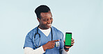 Nurse, man and phone in studio with green screen, point and advertising promotion for telehealth app. Happy, black person or healthcare worker with tech, medical site or marketing on blue background.
