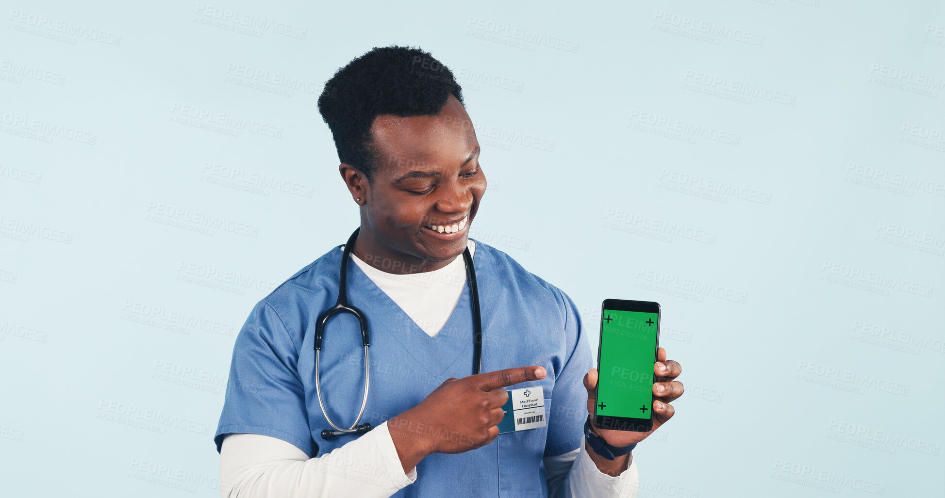 Buy stock photo Nurse, point or phone in studio with green screen, man and advertising promotion for telehealth app. Happy, black person or healthcare worker with tech, medical space or marketing on blue background.