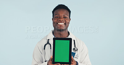 Buy stock photo Portrait, tablet and African doctor with green screen, mockup space or healthcare news. Happy, advertising and man on tech for medical service, telehealth app or wellness info on studio background