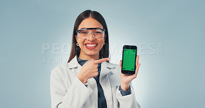 Buy stock photo Green screen, pointing and phone with portrait of scientist in studio for research, medical app or mockup. Science, healthcare portal and space with woman on white background for biotechnology report