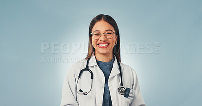 Buy stock photo Portrait, doctor and woman in studio with smile, medical career and cardiology expertise with glasses. Happy, person and cardiologist with healthcare job, about us or mockup space on blue background.