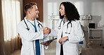 Healthcare, handshake and tablet with doctors in hospital together for advice, deal or feedback. App, collaboration and review with happy medical people shaking hands in clinic for agreement success