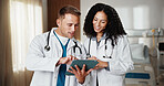 Happy, healthcare and tablet with doctors in hospital together for advice, discussion or feedback. App, pointing and review with medical people in clinic for digital diagnosis, help or support