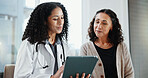 Clinic, patient and doctor with tablet, consultation and explaining medical diagnosis or healthcare. Hospital, health professional and happy women with technology, checkup and reading test results