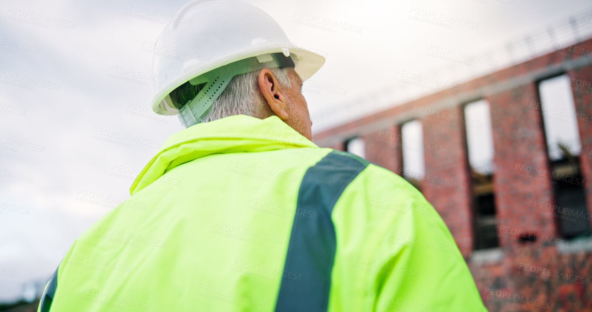 Buy stock photo Construction, back or man outdoor with inspection, safety check or quality control in building project. PPE, below or mature builder with helmet, progress track or evaluation in industrial compliance