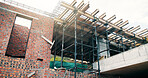 Concrete, construction or scaffolding with brick wall for strength, reinforcement or architecture. Empty, iron or bars with cement or beams for durable building, masonry or structure industry on site