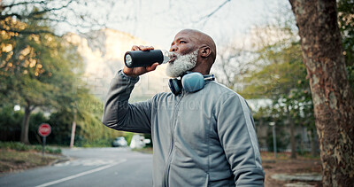 Buy stock photo Drinking water, exercise and thinking with black man outdoor for break, training or workout routine. Fitness, headphones and serious with mature runner in neighborhood for hydration or streaming