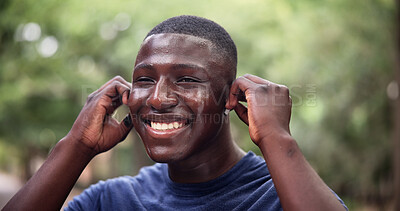 Buy stock photo Fitness, earphones or black man in park with smile, online radio or song subscription for workout activity. Happy, bokeh or athlete with tech, music streaming or audio listening for outdoor exercise.