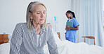 Thinking, old woman and sad in bedroom at hospital, recovery and patient with chronic illness. Sorrow, senior person and vision with nurse for bad news, cancer diagnosis and geriatric rehabilitation