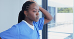 Nurse, window and black woman thinking in hospital with reflection for memory or mental health. Thoughtful, female person or contemplating ambition for mistake or fail in medical nursing 