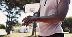 Hands, person and finger pain with injury on basketball court for exercise, fitness or training accident. Park, sports athlete and massage muscle for fibromyalgia, arthritis or health crisis outdoor