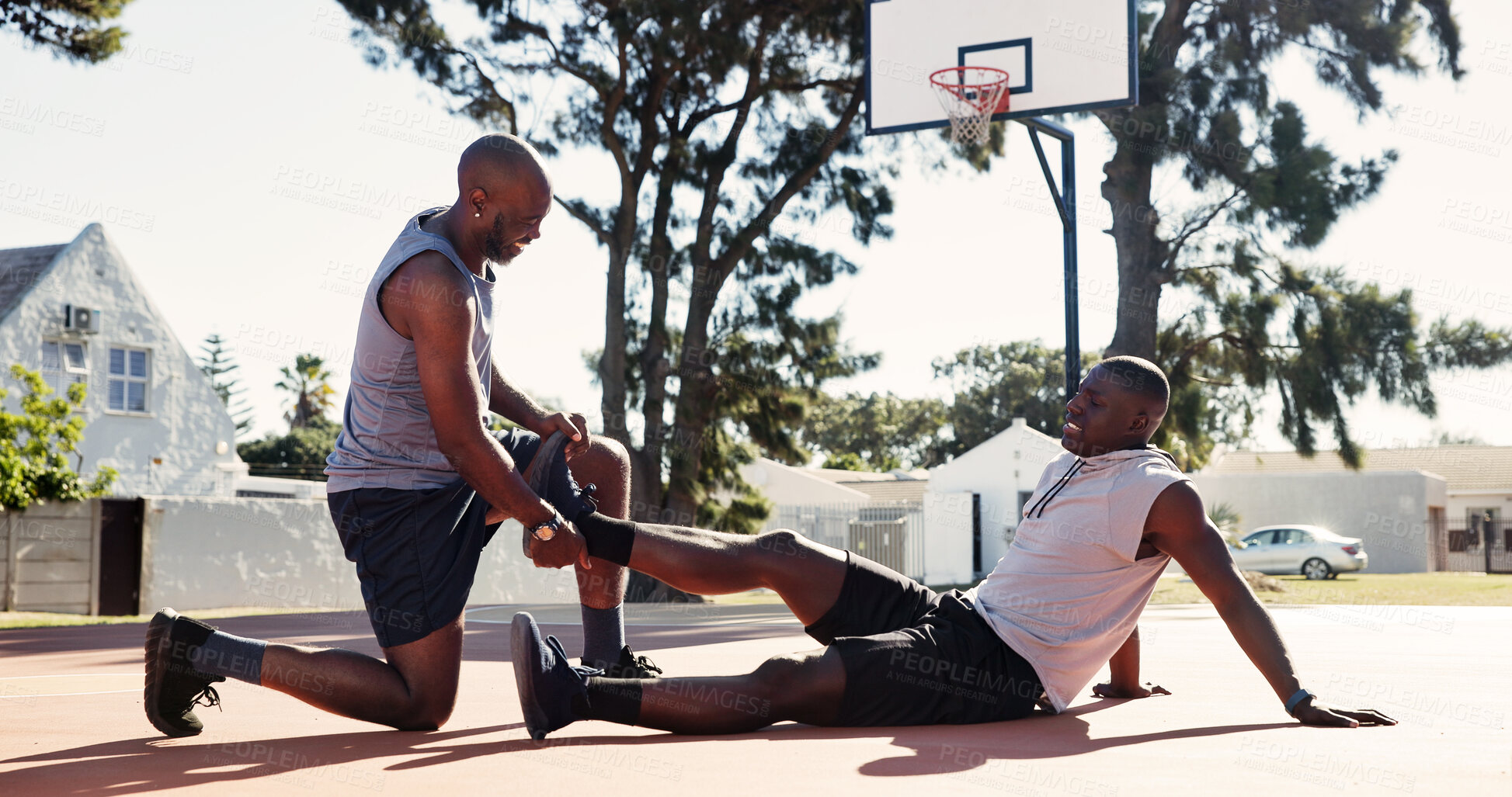 Buy stock photo Basketball court, help and black man with leg pain, accident or support with first aid outdoor. Game, African friends and player with sports injury on ground for fitness, training and muscle cramp