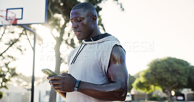 Buy stock photo Man, text and fitness at basketball court with phone, social media app or browse on exercise break. Online, active black person and outdoor with tech, sports website or typing message in summer