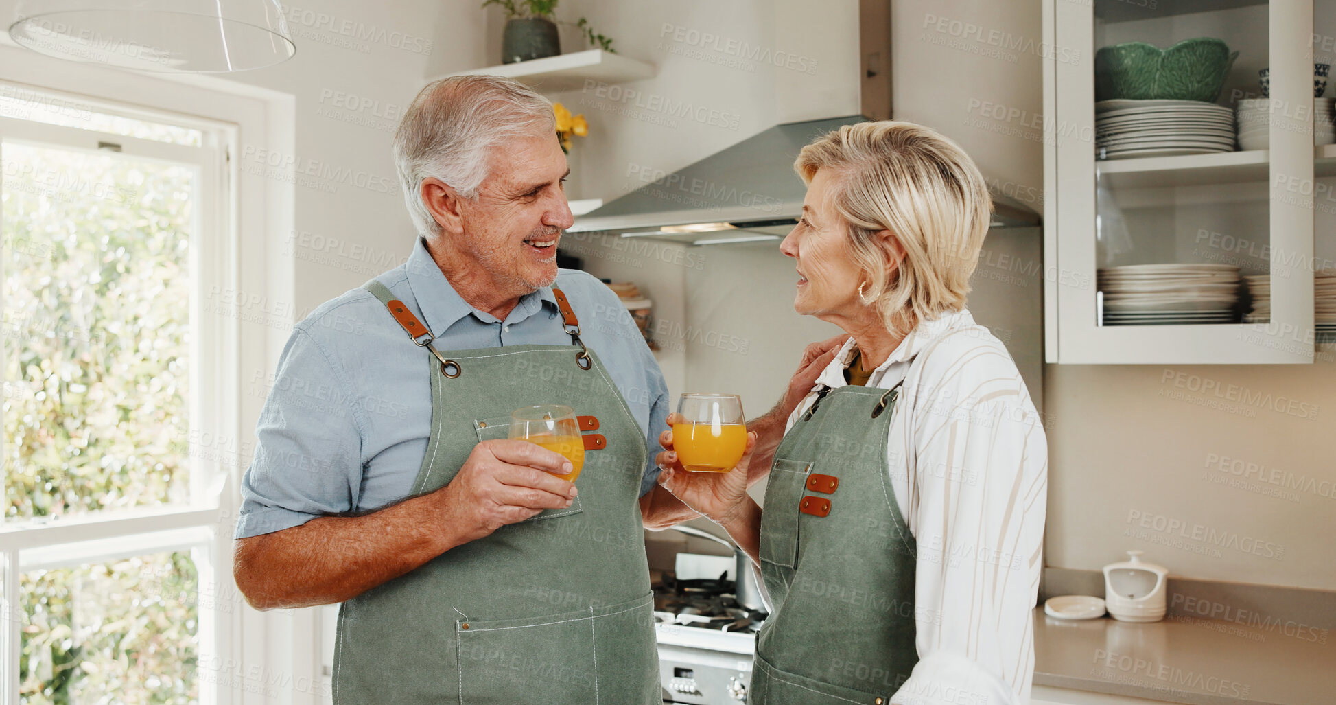 Buy stock photo Cooking, happy and old couple in kitchen with orange juice, bonding together and retirement wellness. Married, senior people and meal preparation in house with healthy drink, nutrition and support.