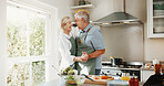 Cooking, happy and senior couple dance in kitchen for help, bonding and meal prep in home. Marriage, retirement and man with woman with music for relationship, love and prepare dinner together