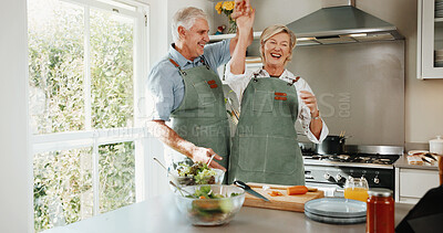 Buy stock photo Cooking, fun and old couple in kitchen with dance, happy moment and bonding with culinary hobby. Smile, rhythm and senior people with meal prep, groove together and romantic connection in house.