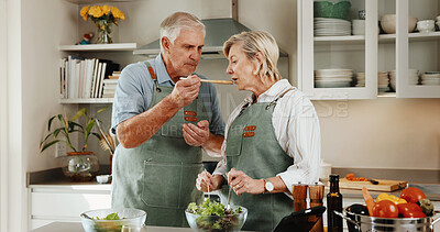 Buy stock photo Cooking, support and old couple in kitchen with tasting, connection and bonding with meal prep. Retirement, food sampling and elderly people with spoon, healthy relationship or culinary hobby in home