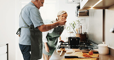 Buy stock photo Cooking, taste and senior couple in kitchen with help, connection and bonding with meal prep. Retirement, food sampling and elderly people with support, healthy relationship or culinary hobby in home