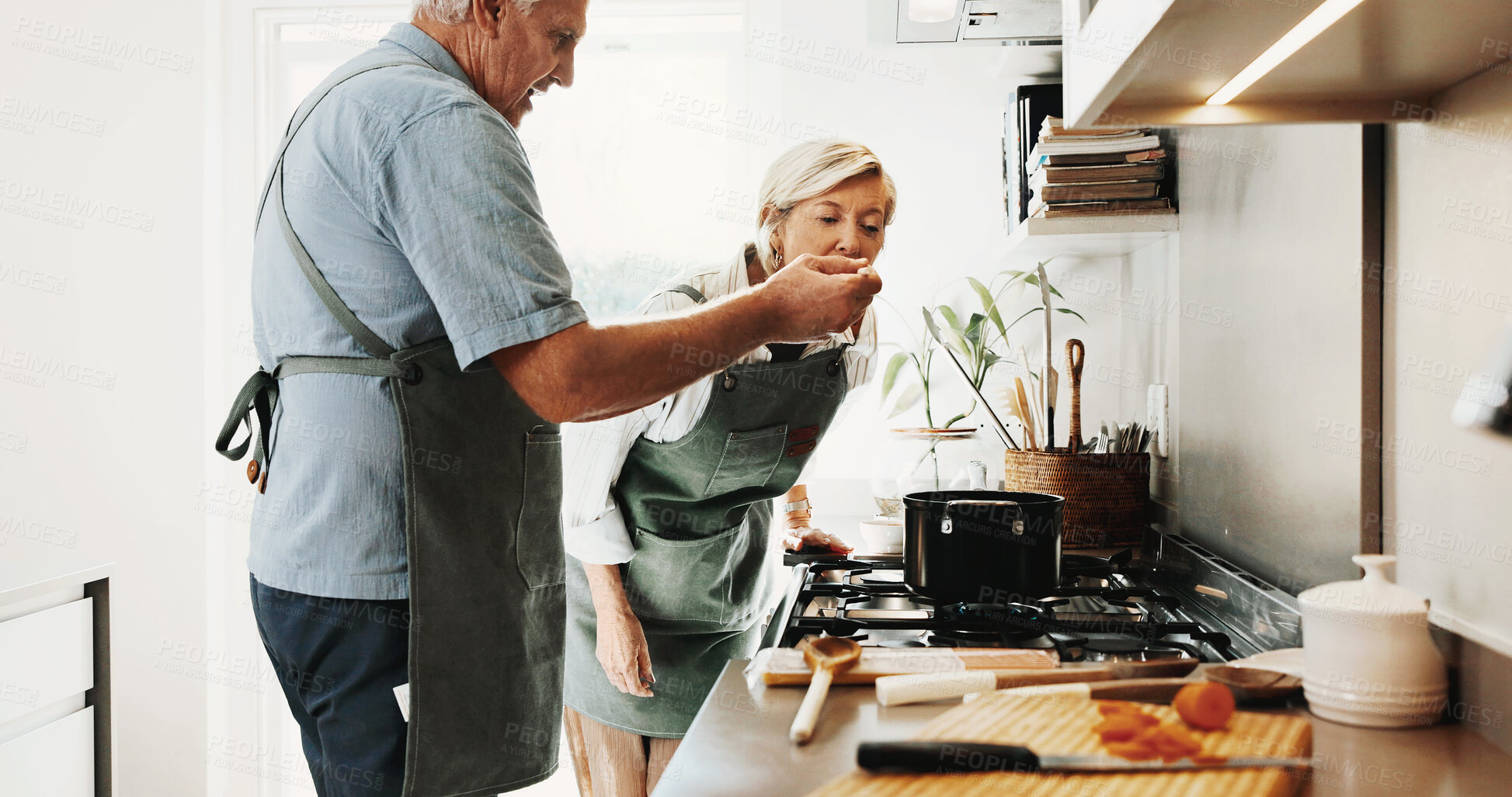 Buy stock photo Cooking, taste and senior couple in kitchen with help, connection and bonding with meal prep. Retirement, food sampling and elderly people with support, healthy relationship or culinary hobby in home