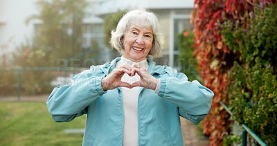 Buy stock photo Happy, portrait and old woman with heart hands in garden, kindness sign and support symbol on break. Outdoor, pensioner and senior person with smile, care and confident with love gesture in nature