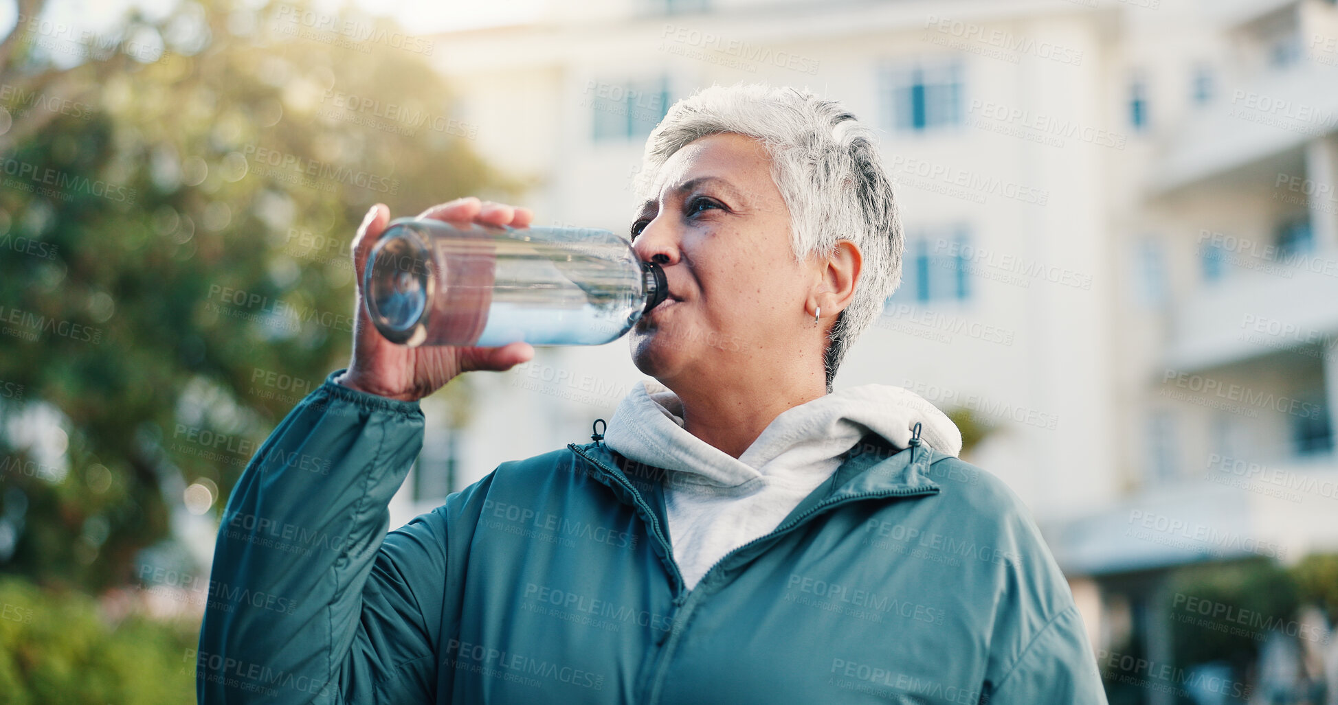 Buy stock photo Exercise, drink and senior woman in city for rest, workout recovery and hydration with bottle. Fitness break, active retirement and person with water for health, beverage and thirsty with runner