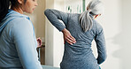 Chiropractor, help and old woman in clinic with back pain, consultation and assessment for healing. Senior person, chiropractic worker and spine injury in office for evaluation, support or assistance