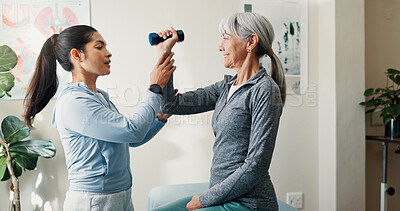 Buy stock photo Consulting, dumbbell and rehabilitation with women in session together for exercise or healing. Fitness, physiotherapy and senior person with chiropractor in health clinic for strength training