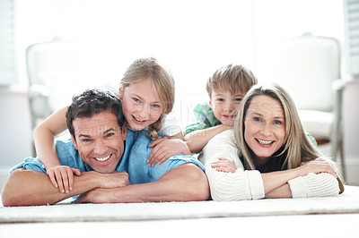Buy stock photo Floor, happy and portrait of kids with parents in home for bonding, love and care on weekend. Relax, pride and children with mom and dad on carpet for family, safety or connection in living room.