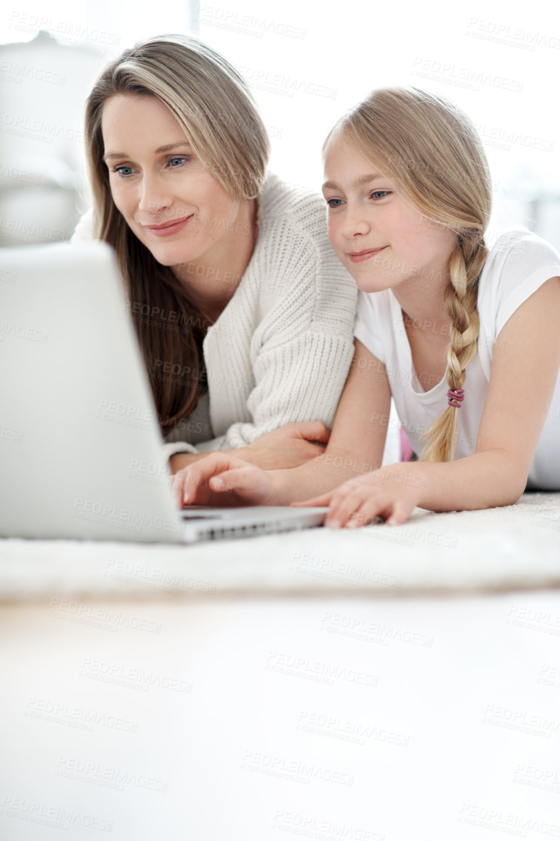 Buy stock photo Elearning, mom and child with laptop in lounge, research and help with homework on website in house. Family, online education and happy woman with daughter, space and studying with parent in home