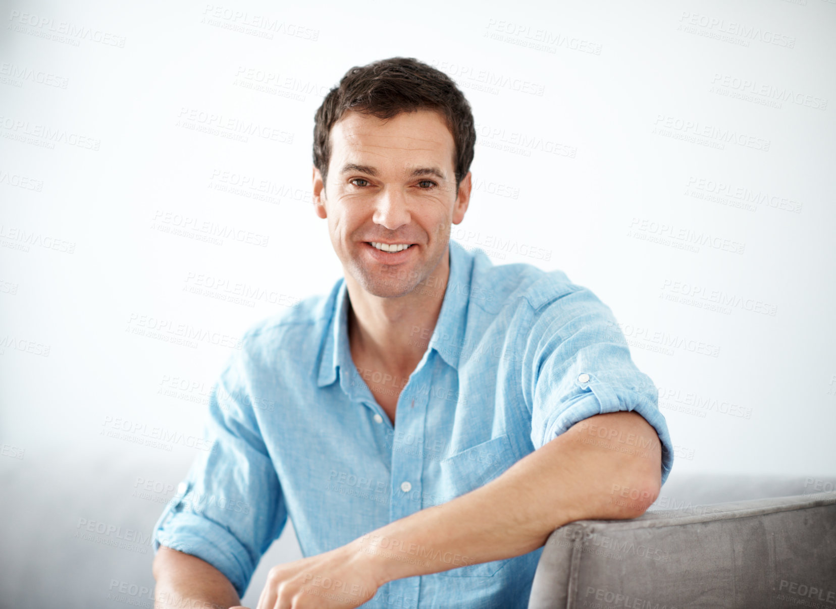 Buy stock photo Portrait, man and relax in living room with smile, positive attitude or chill on peaceful weekend break. Happy, mature person and calm in home with comfortable sofa, rest and good mood for wellness.