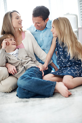 Buy stock photo Happy, parents and relax in home with children, love or parental support for bonding together. Smile, people and laughing in living room with kids, comfortable and family connection for weekend break
