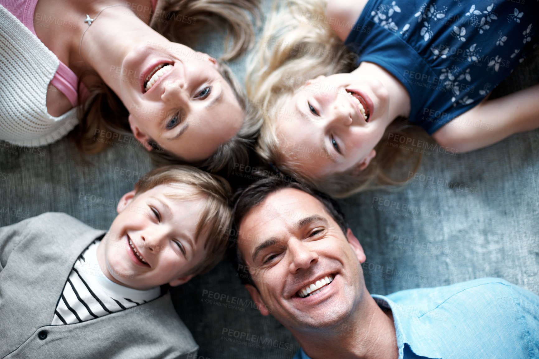 Buy stock photo Portrait, parents and relax on floor with kids, love and parental support for bonding together. Above, people and happiness at house with children, comfortable and family connection for weekend break