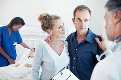 Buy stock photo Consulting, feedback and pediatrician speaking to parents in hospital for care of daughter. Clipboard, comfort and news with doctor talking to people in clinic for child healthcare or medical report
